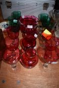 A selection of clear and cut stemmed wine glasses in Jade green and Ruby colours in fine condition