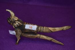 A pair of antique cigar or similar cutters having carved bone handles with mythical elephant and