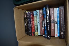 A selection of action and fantasy books including Patrick Moore on the Moon