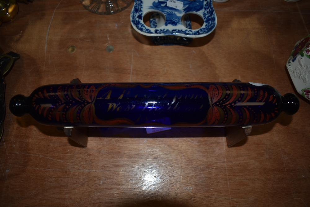 A mid 18th century Bristol blue glass bakers rolling pin having painted decoration and date