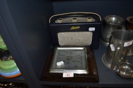 A vintage Roberts radio having deep blue vinyl case and an oak cased square barrometer