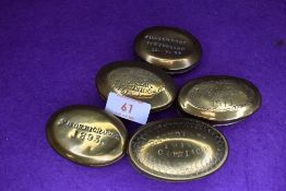 A selection of late Victorian brass cast snuff or pill containers including Cromlach Bargoed and