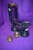 A set of falcon mounted weighing scales and accompanying brass weight set