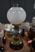 A fine Victorian oil lamp having blue glass well with brass and ceramic base