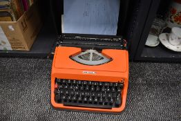 A genuine vintage typewriter by Underwood having case and orange body