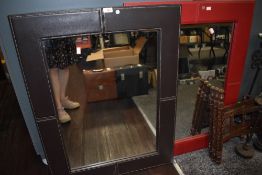 A pair of modern mirrors having leather frame in brown and red colour ways