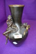 A Victorian bronze vase having ormalu decoration with bronze cast figures of cherub and maiden