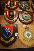 Six wooden heraldry shields including H.M.S Collingwood and Royal Air force station.