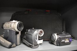 Three digital video cameras. A Sony 2000X, a Sony Handycam and a JVC Evario in soft camera bag