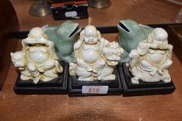 Three Chinese figures of evil and a pair of frog style posy vase