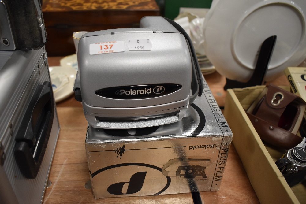 A Poloroid Moment instant camera in original box