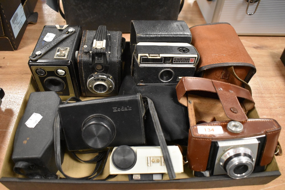 A box of various vintage cameras including Kodak Brownie, Instamatics, Coloursnap 35 and Gevabox