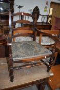 A traditional stained frame low seat carver chair having ladder back