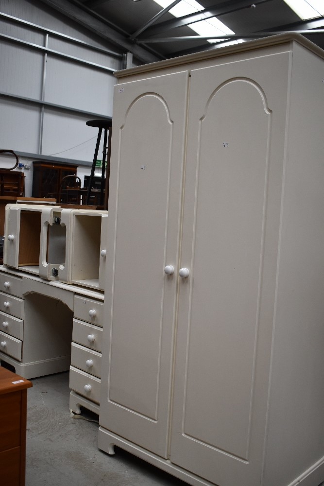 A selection of modern laminated white bed room furniture including bedside cabinets dressing table