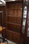 A late C20th oak effect bookshelf with cupboard under, approx w 80cm