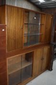 Two vintage sapele cabinets with glazed bookshelf and cupboard sections, each width approx. 136cm