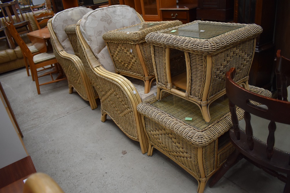 A selection of conservatory wicker woven furniture including two large tub chairs and four