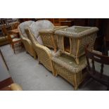 A selection of conservatory wicker woven furniture including two large tub chairs and four