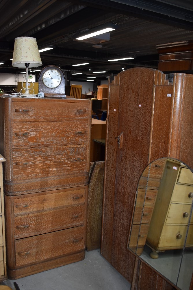 A 1930s limed oak compact bedroom suite comprising , single wardrobe, bed frame, chest of drawers