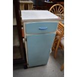 A mid century utility kitchen cupboard in duck egg blue