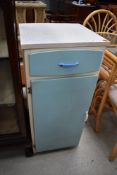 A mid century utility kitchen cupboard in duck egg blue