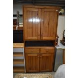 A hard wood kitchen utility or larder cupboard having drawer set and double cupboard