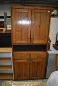 A hard wood kitchen utility or larder cupboard having drawer set and double cupboard