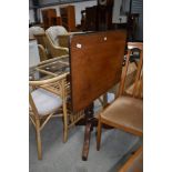 A late Victorian tilt top tea table having turned base