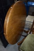 A modern pine circular kitchen extendable table