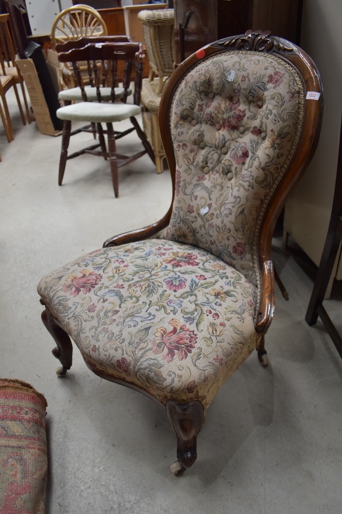 A late Victorian carved mahogany framed nursing chair