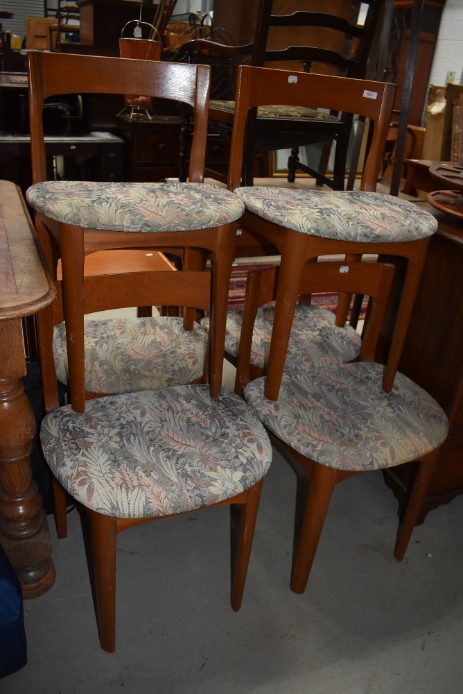 A set of six 1970s style teak dining chairs having upholstered seats