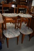 A set of six 1970s style teak dining chairs having upholstered seats