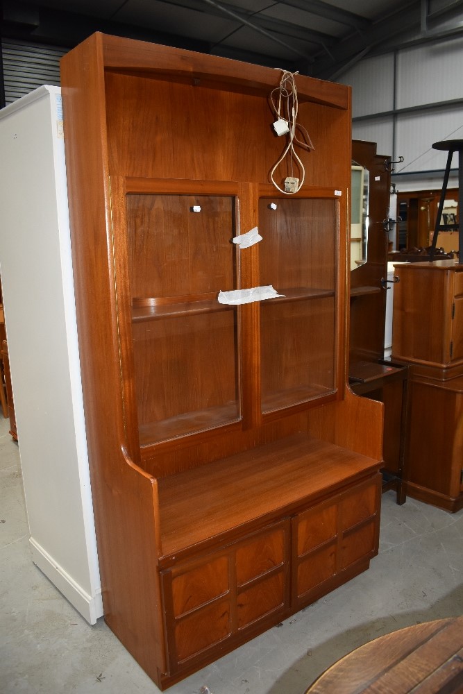 A mid century teak display cupboard having glazed top and cupboard base by Nathan