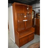 A mid century teak display cupboard having glazed top and cupboard base by Nathan