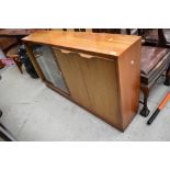 A mid century office or library book and cupboard unit wit glazed front