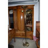 A vintage brass trifold fireguard and a modern reading lamp/uplighter