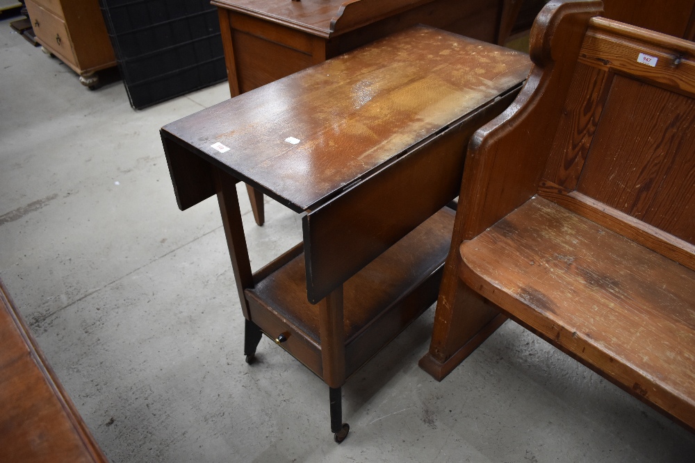 An early mid century tea trolley having atomic style legs with fold out top