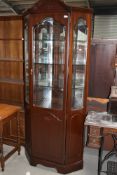 A modern mahogany effect display cabinet, having mirror back