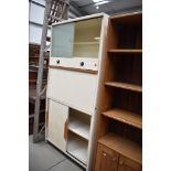 A mid century kitchen storage cabinet or larder by Hollins with original glass interior