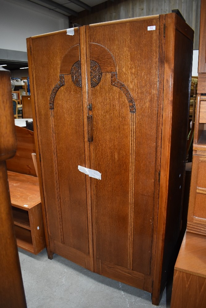 An Edwardian wardrobe with oak carcass and decorative front panel 91cm wide