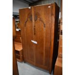 An Edwardian wardrobe with oak carcass and decorative front panel 91cm wide