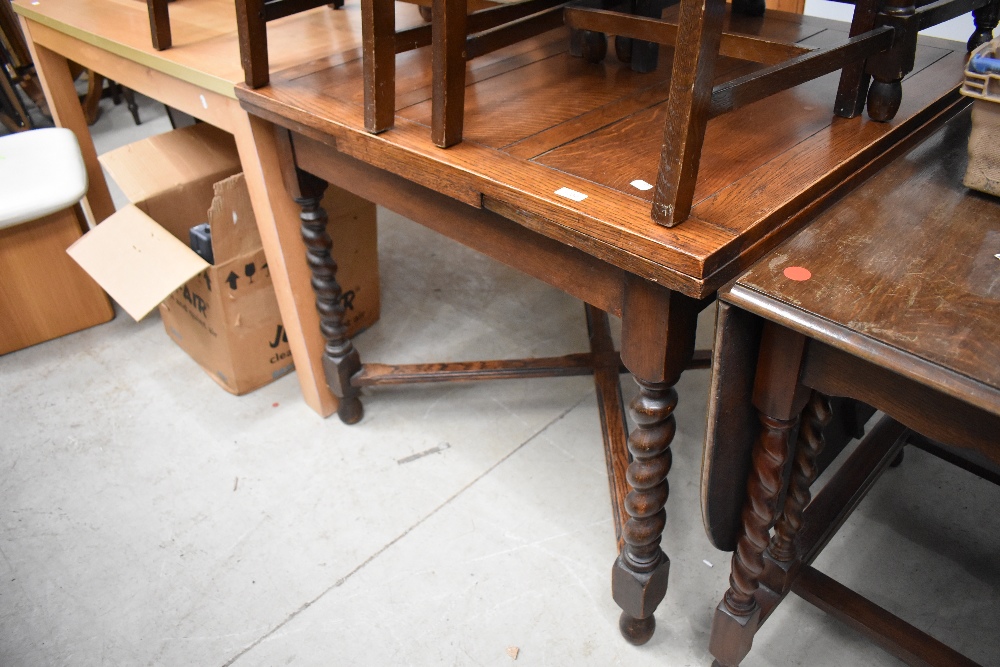 A traditional oak dining table being extendable with barley twist legs