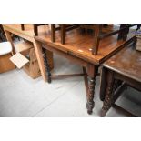 A traditional oak dining table being extendable with barley twist legs