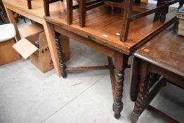 A traditional oak dining table being extendable with barley twist legs