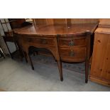 An Regency style side board having tapered legs with extensive inlay detailing