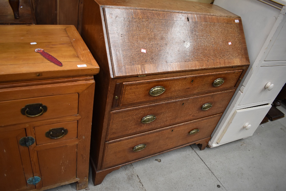A late 19th century oak bureau desk having oak carcass with well constructed inner compartments