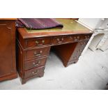 A modern office knee hole desk having solid wood carcass with green leather top in great condition
