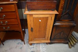 An Edwardian golden oak pot cupboard