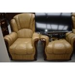 A modern leather three piece suite, in tan with highly polished frame