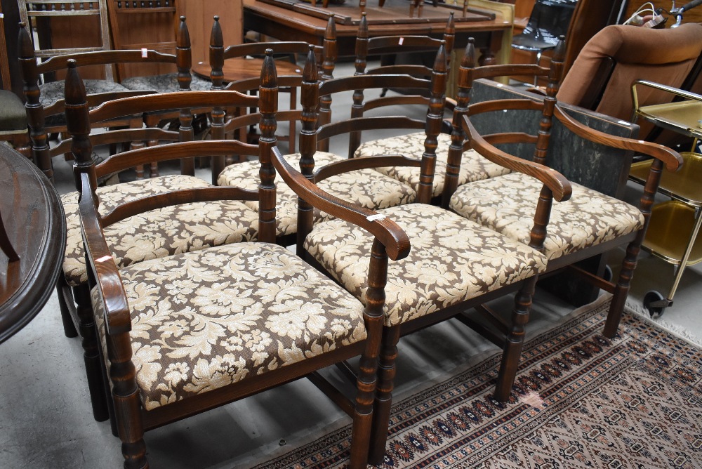 A pair of reproduction oak rail back carver chairs having turned frames